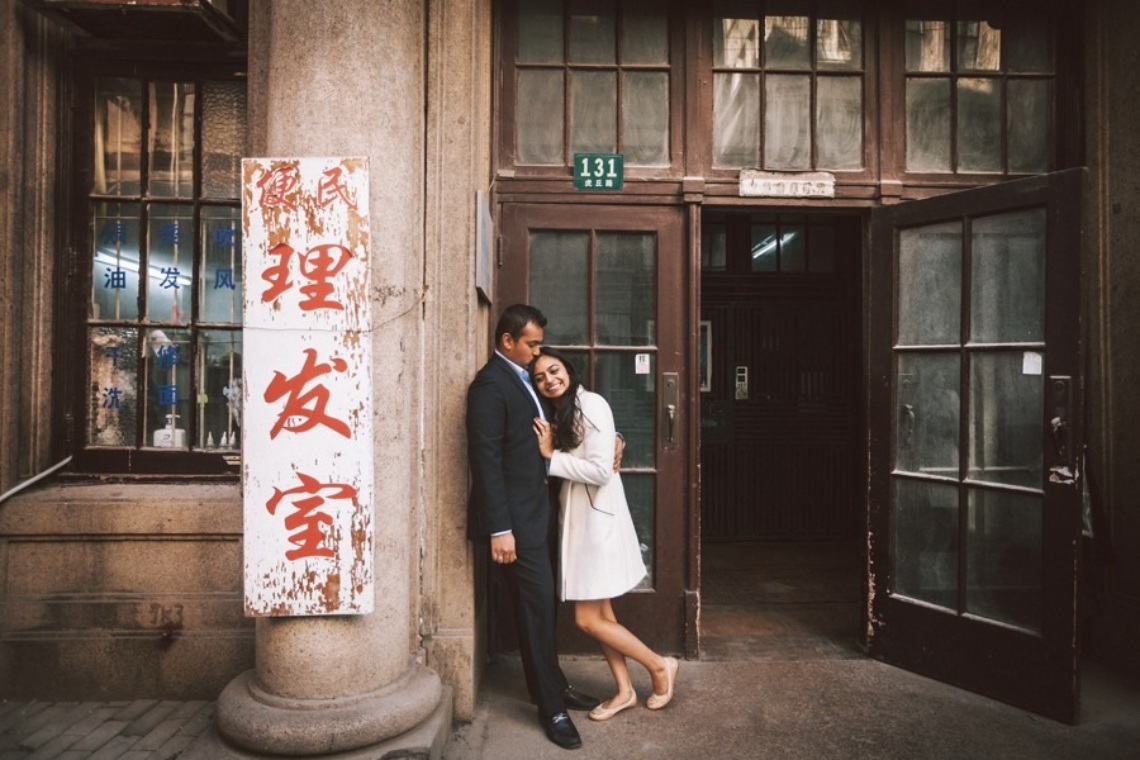Couple posing in front of a building in the old streets of Shanghai